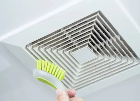 Advanced air duct sanitization service with cleaning brush on ceiling vent in West Bend WI.