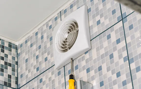 Bathroom fan cleaning service with bathroom exhaust fan in tiled bathroom in Oshkosh WI.