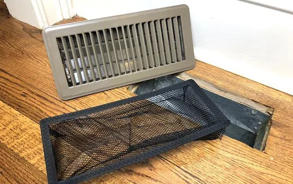 Bathroom fan vent with removed filter for cleaning to improve ventilation in Manitowoc WI.