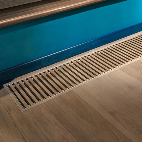 Close-up view of clean floor air duct vent grille showing results of professional air duct cleaning services.