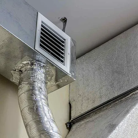 Clean commercial metal air duct with ventilation grille after professional duct cleaning in Madison WI.
