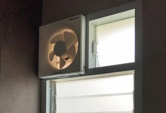 Bathroom exhaust fan installed in window for improved ventilation and moisture control.