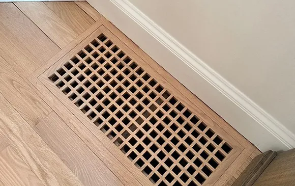 Clean floor air duct vent grille as part of HVAC duct cleaning service in Manitowoc WI.