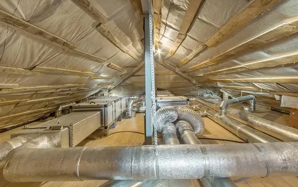 Effective air duct disinfecting services for commercial HVAC ductwork in building attic.