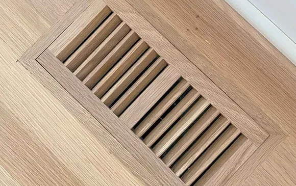 Emergency air duct cleaning service showing clean floor vent grille in Oshkosh WI.