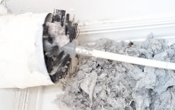 Expert dryer vent cleaning services using rotary brush to remove lint buildup inside vent.