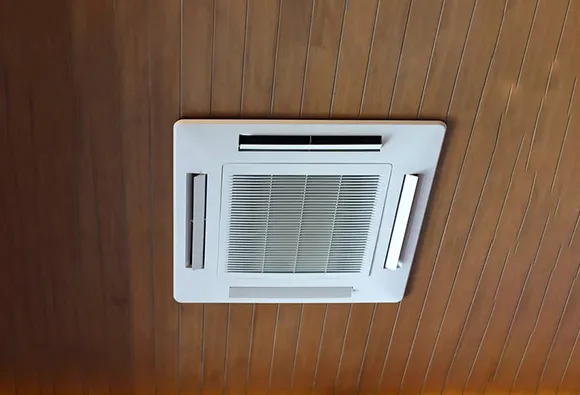 Air duct installed in ceiling with wood paneling for leading air duct cleaning service company.