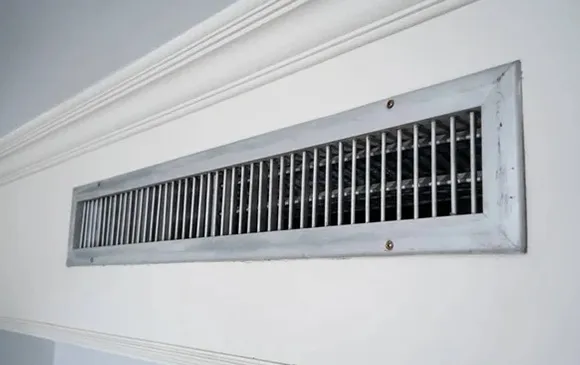 Long horizontal air vent in hallway or room for professional HVAC duct cleaning service.
