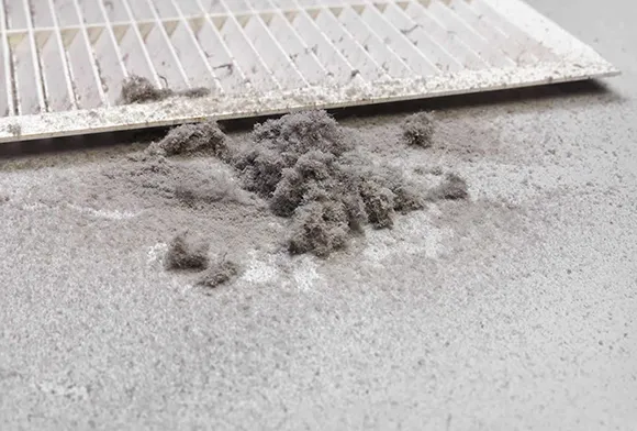 Commercial air vent covered with dust and debris needing safe mold and debris removal in Brookfield WI.