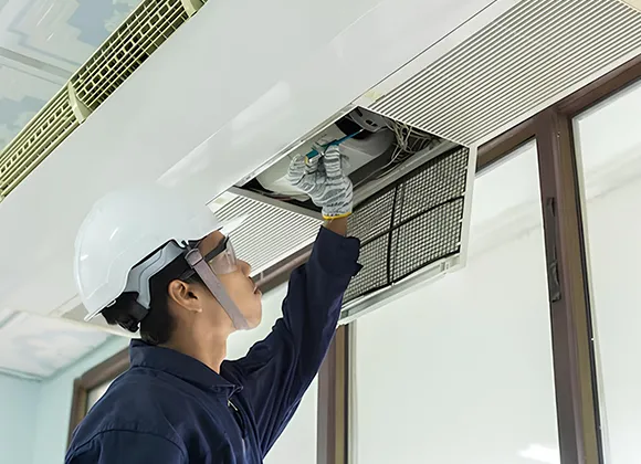 Thorough air duct disinfecting service applying disinfectant spray to ceiling vent in Oshkosh WI.