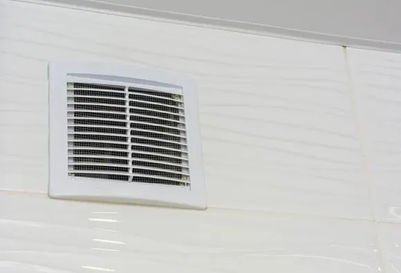 Thorough air duct sanitization service with clean HVAC vent grille in residential home in Manitowoc WI.