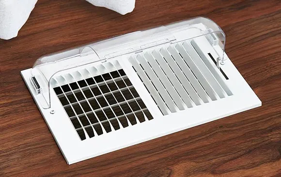 Trusted air duct cleaning company showing white floor air vent grille in Oshkosh WI.