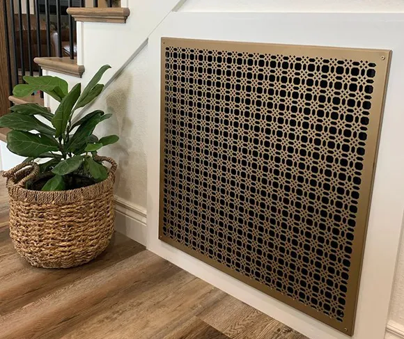 Decorative home air vent cover installed near indoor plant on hardwood floor in Appleton residence.