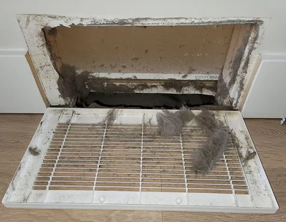 Professional duct mold removal showing severely mold-contaminated residential air vent in West Bend WI.